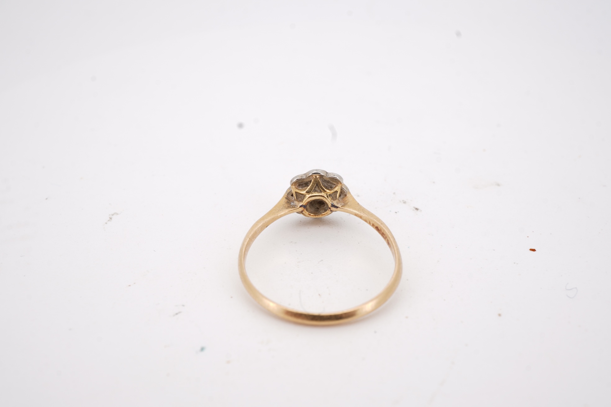 Three rings, comprising: a platinum wedding band, size N1/2, stamped PLAT, gross weight 3 grams; a bicoloured band, size J, stamped PLATINUM 22CT, gross weight 3 grams; and a ring set with a diamond weighing approximatel